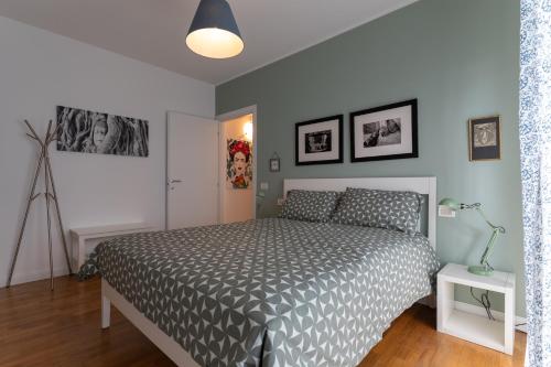 a bedroom with a bed with a gray comforter at Il Piccolo Giardino in Crespellano