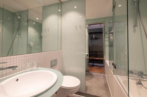 a bathroom with a sink and a toilet and a shower at Imperial Hotel in Copenhagen