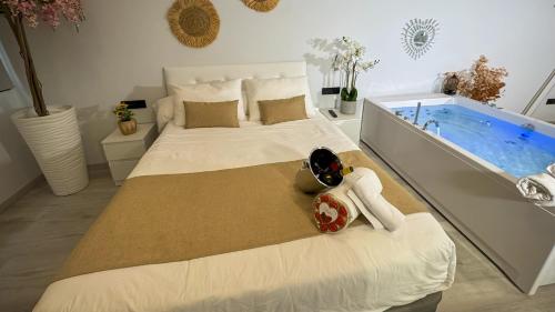 a bedroom with a large bed and a bath tub at El Rincón Secreto in Alcalá del Júcar