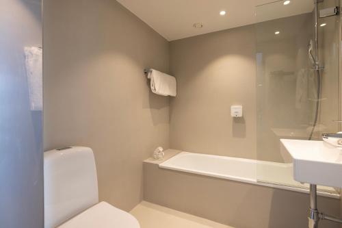 a bathroom with a toilet and a sink and a shower at Imperial Hotel in Copenhagen
