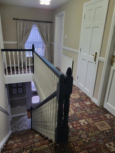 a stairway leading to a room with a door at Kesh self catering holiday home. in Kesh