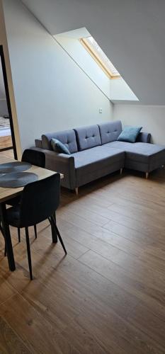 a living room with a couch and a table at Apartament zamkowa 1 in Żywiec