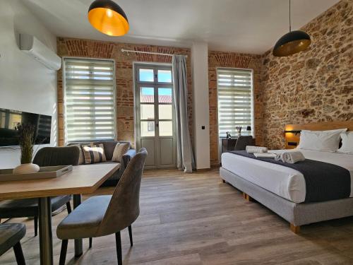 a bedroom with a bed and a dining room at Silk Suites by YHA in Athens