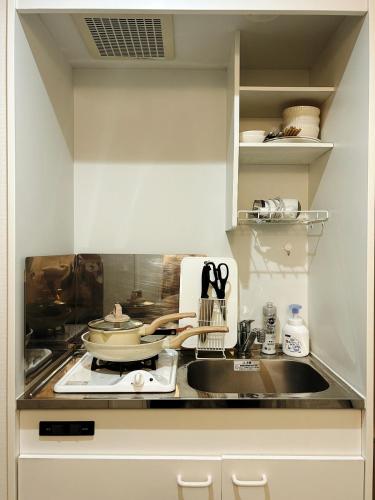 a kitchen with a sink and a counter top at Shin-Koenji loft apartment close to Tokyo Metro14mins to Shinjuku in Tokyo