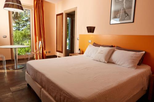 a bedroom with a large bed and a large window at Villa Solaria in Massa Lubrense