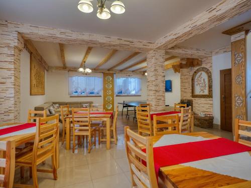a dining room with wooden tables and chairs at Willa Pod Reglami - Małe Ciche - Sauna & Jacuzzi - 400m od Stacji Narciarskiej in Male Ciche