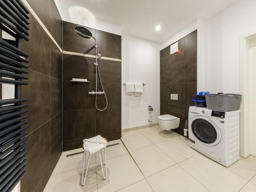 ein Badezimmer mit Waschmaschine und Toilette in der Unterkunft ALTE SEEFAHRTSCHULE - ZWEI WASSER App 11 "Mohnblume" in Wustrow