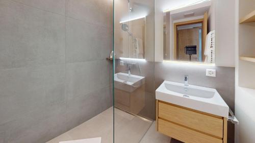 a bathroom with a sink and a shower at Leonard in Celerina