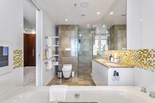 a bathroom with a tub and a sink and a shower at QV Stays Luxury Suite with Views Galore in Auckland