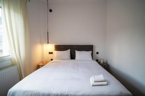 a bedroom with a large bed with two towels on it at Sylvia's Pramanta Villas in Pramanta