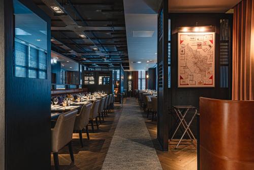 a dining room with long tables and chairs at Dakota Newcastle in Newcastle upon Tyne