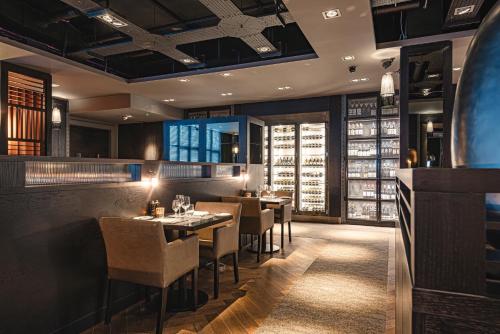 a restaurant with tables and chairs in a room at Dakota Newcastle in Newcastle upon Tyne