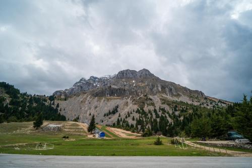 a large mountain in the middle of a field at Sylvia's Pramanta Villas in Pramanta
