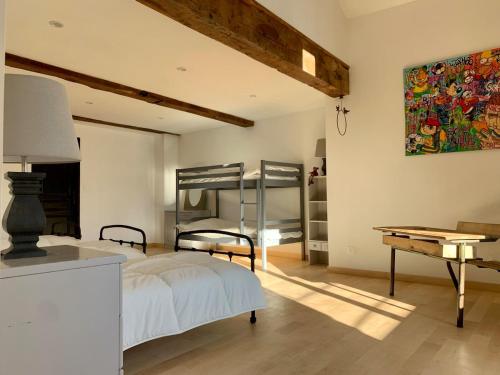 une chambre avec un lit, une table et un bureau dans l'établissement Les sources d avenas, à Saint-Jean-Roure