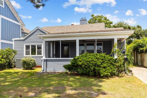 a gray house with a yard at The Gray Whale Cottage home in Beaufort