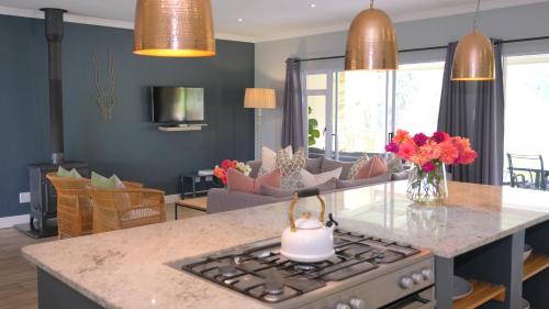 a kitchen and living room with a stove top oven at Saints Rest in Clarens