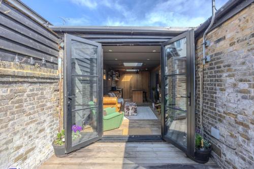 an open door into a room with a brick wall at The Stables in Southend-on-Sea