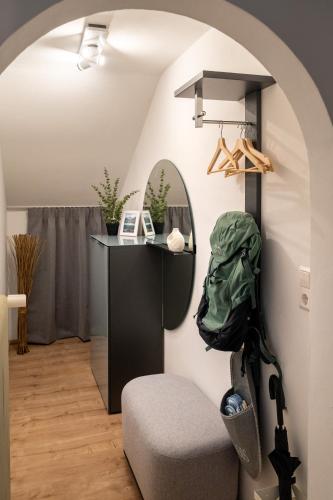 a living room with a chair and a mirror at BETTSTOD - da legst di nieder in Spiegelau