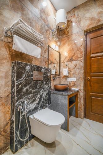 a bathroom with a toilet and a sink at Royal Delight Resort in Madīna