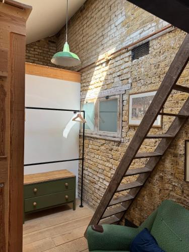 a staircase in a room with a brick wall at The Stables in Southend-on-Sea