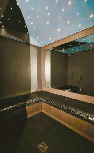 a room with a bath tub and a mirror at HA Hotel in Bracciano