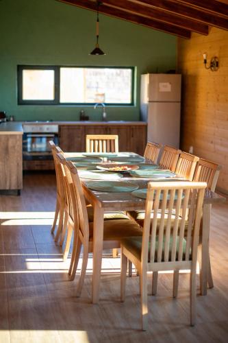 a dining room table and chairs in a kitchen at Casa Rustică in Călăţele