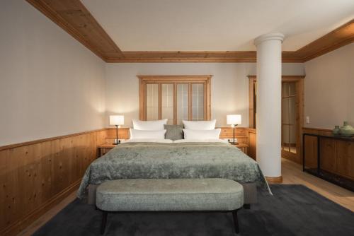 a bedroom with a large bed with white pillows at Schlosshotel Fiss in Fiss