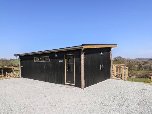 a black building with a door on top at Bryn Hafod in Llandrindod Wells