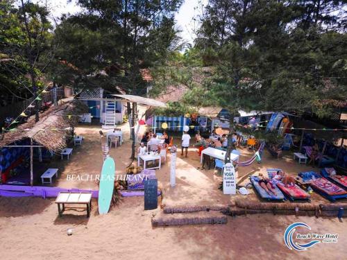 an aerial view of a beach with people and surfboards at Beach Wave Hotel in Arugam Bay