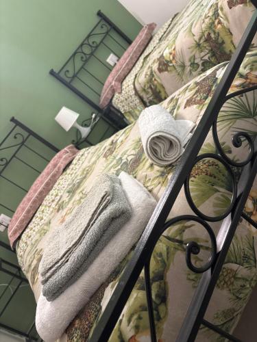 a couch with a blanket and towels on a rail at B&B Sole e Luna in Ponte Galeria