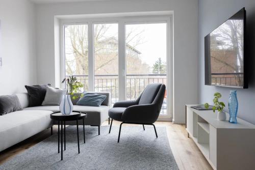 a living room with a couch and a chair at Mole in Sankt Peter-Ording