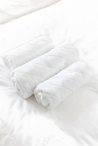 an unmade bed with white sheets and pillows at Strand in Sankt Peter-Ording