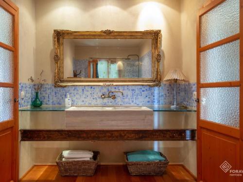 a bathroom with a large mirror and a sink at Son Senyor in Sa Pobla