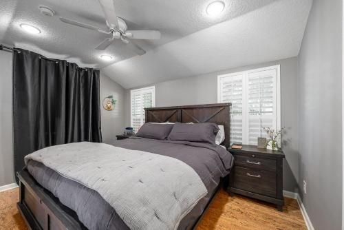 a bedroom with a bed and a ceiling fan at Charming 3BR Home Near DT with King Bed and Fire Pit in Orlando