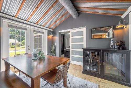 a dining room with a table and a mirror at Charming 3BR Home Near DT with King Bed and Fire Pit in Orlando