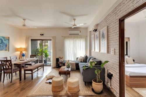 a living room with a bed and a dining room at 2bhk Bruno Nera Candolim 10 mins to beach in Nerul