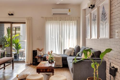 a living room with a couch and a table at 2bhk Bruno Nera Candolim 10 mins to beach in Nerul
