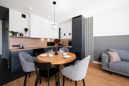 a kitchen and dining room with a table and chairs at Apartamenty Rocha in Pabianice