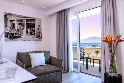 a living room with a couch and a table at Hilton Sorrento Palace in Sorrento
