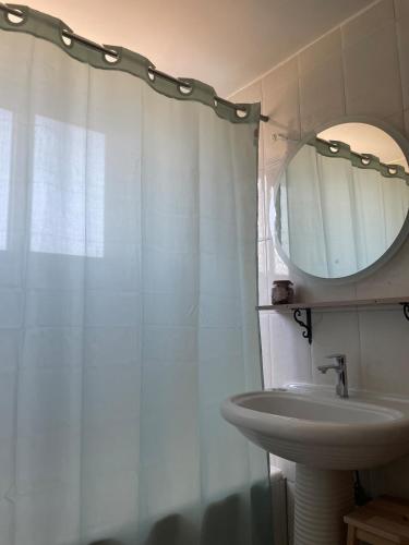 a bathroom with a sink and a mirror at Sakuras House in Pesádha