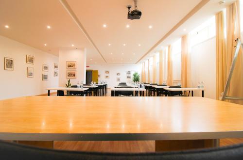 a large table in a room with tables and chairs at HA Hotel in Bracciano