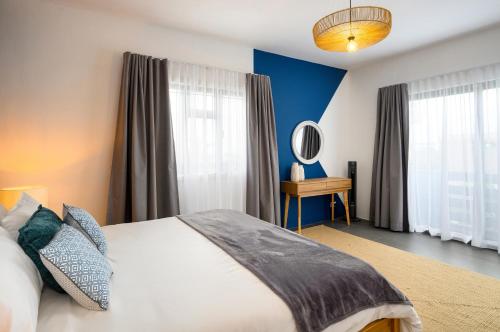 a bedroom with a bed and a mirror at Wild Pearl, Albion Mauritius in Albion