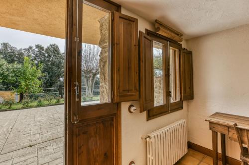 a door to a room with a table and a window at Habitacions Mas Fuselles in Girona