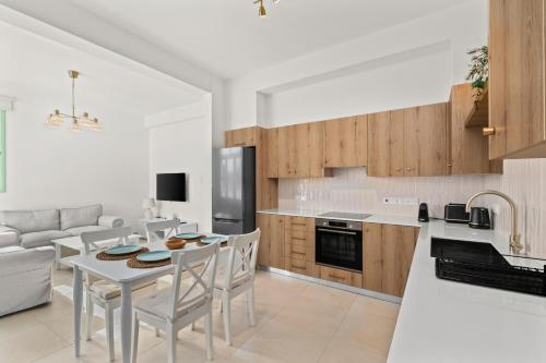 a kitchen and living room with a table and chairs at Lito - Slow Living in Larnaka
