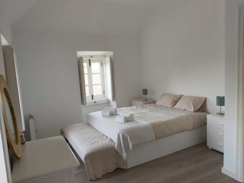 En eller flere senge i et værelse på Casa da Biquinha