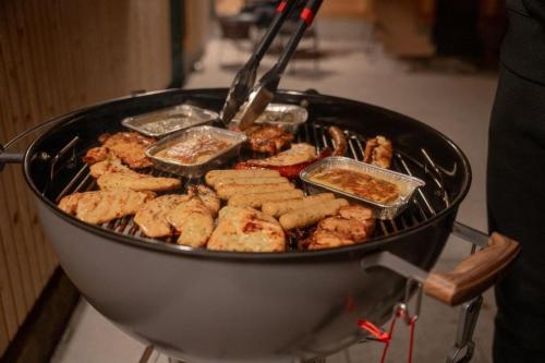 a grill with chicken and other foods on it at Ferienhaus Gersmühle in Satteldorf