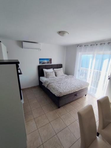 a bedroom with a bed with pillows on it at Apartments with sea view Drvenik Makarska riviera in Drvenik