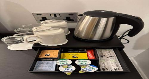 a tray with a coffee pot on top of a counter at Best Western Kensington Olympia Hotel in London