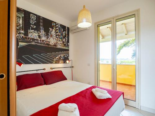 a bedroom with a red and white bed and a window at Villa Mirò - Escape to Salento in Melendugno