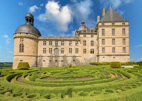 a castle with a garden in front of it at Gite La Grange - Perigord Vert in Saint-Martial-dʼAlbarède
